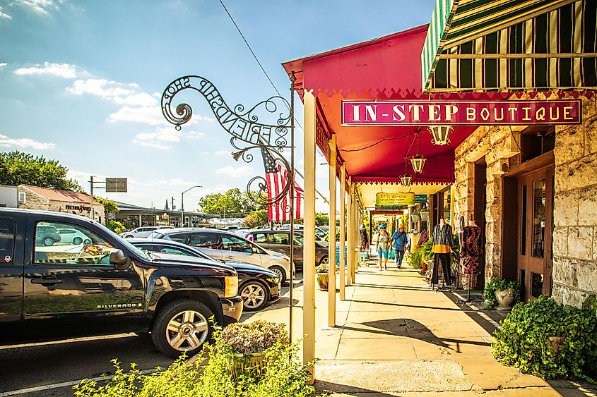 Main Street in Fredericksburg, Texas - Also known as 'The Magic Mile,' featuring retail stores and people walking.