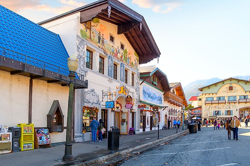 Tourists walk the pedestrian main street of shops and cafes in the Bavarian themed village of Leavenworth in Washington State, USA. Editorial credit: Kirk Fisher / Shutterstock.com