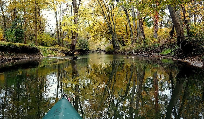 Indiana Dunes National Park, Indiana, fall landscape with forest reflecting in the water. Taken while kayaking along the Calumet river. Beautiful colors and calm still water.