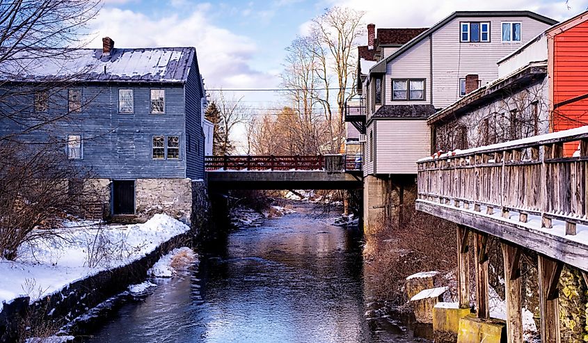 Old buildings lining the Williams River in Stockbridge, Massachusetts.