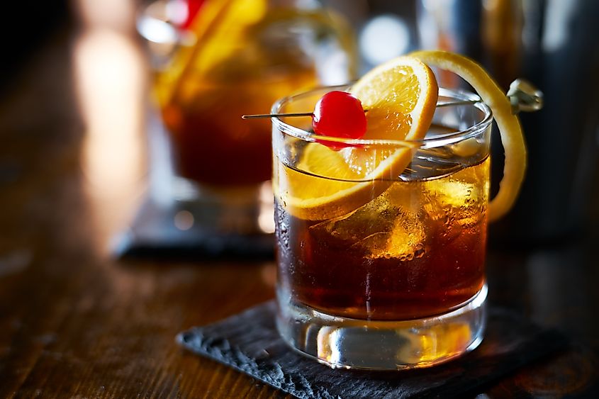 Old Fashioned cocktail with orange slice, cherry, and lemon peel garnish