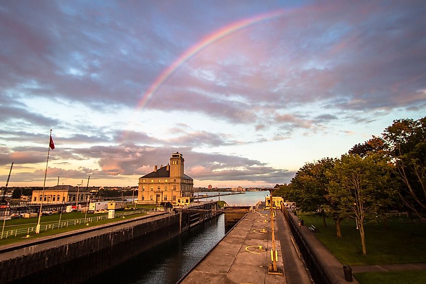 The Soo Locks on the St. Mary's River in Sault Ste. Marie, Michigan framed by a rainbow. Editorial credit: ehrlif / Shutterstock.com