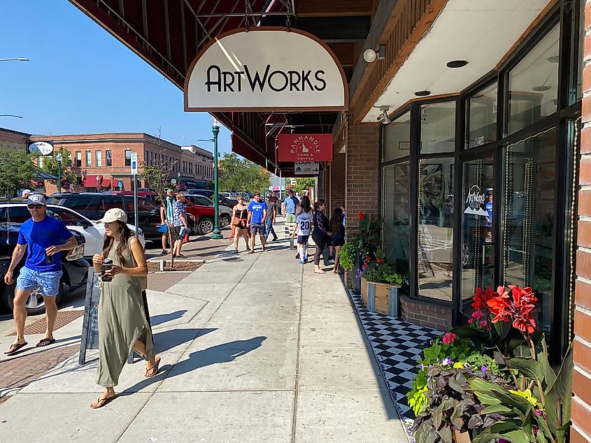 Pedestrians stroll past a coffee shop and art studio in downtown Sandpoint, Idaho.