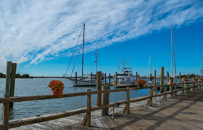 Sailboats in the harbor-Beaufort NC. Blue sky, clouds, tall ships, historic waterfront town, scenes on a sunny day.