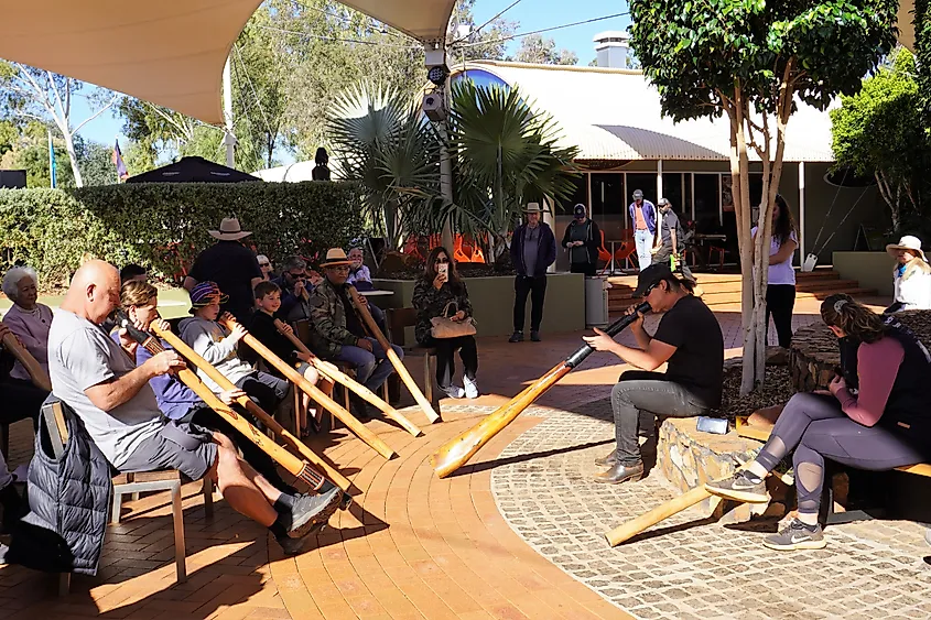 People receiving Didgeridoo Playing Lessons in Yulara, Northern Territory, Australia.