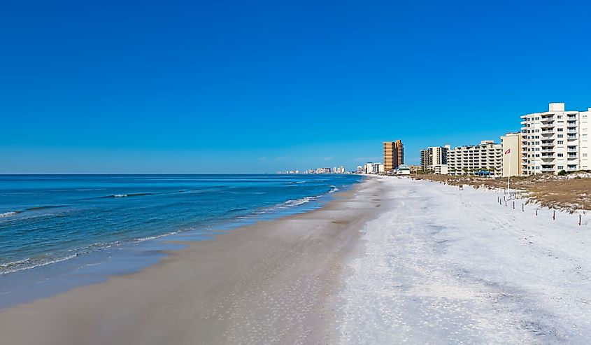 Looking down the sandy beach at Panama City Beach, Florida on a bright winters day