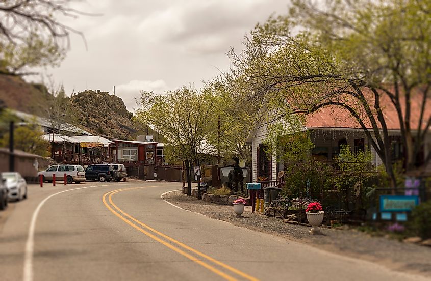 Street scene in Madrid, New Mexico, along the historic Turquoise Trail and Route 66, a scenic byway between Santa Fe and Albuquerque, featuring local shops and rustic buildings.