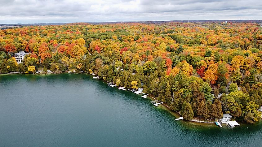 Fall colors surrounding Elkhart Lake in Wisconsin, with vibrant foliage reflecting on the water and scenic landscapes all around.