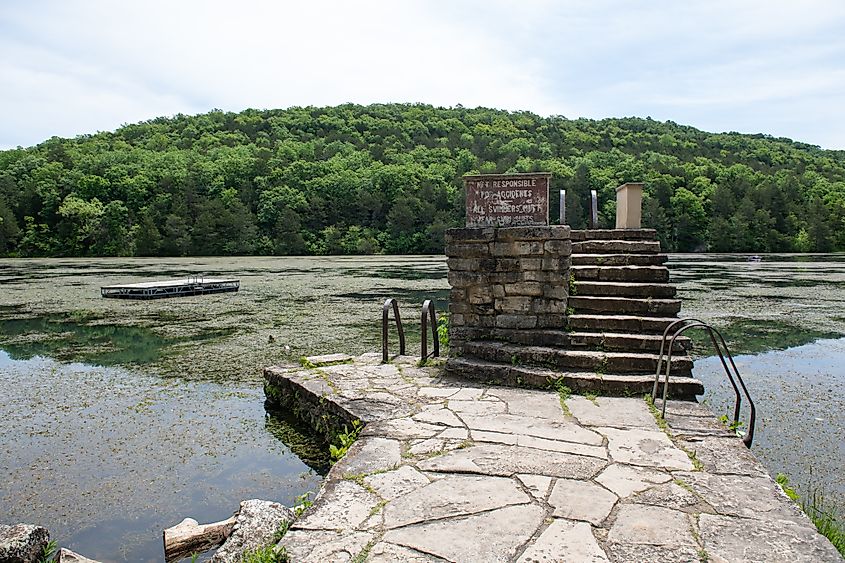 A view of the stone diving board platform with a beautiful scene in the background at Lake Leatherwood in Eureka Springs, Arkansas.