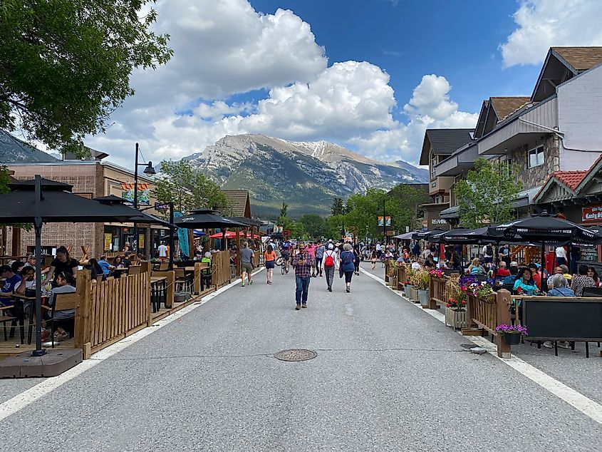 A popular pedestrian street with a large mountain in the background. 