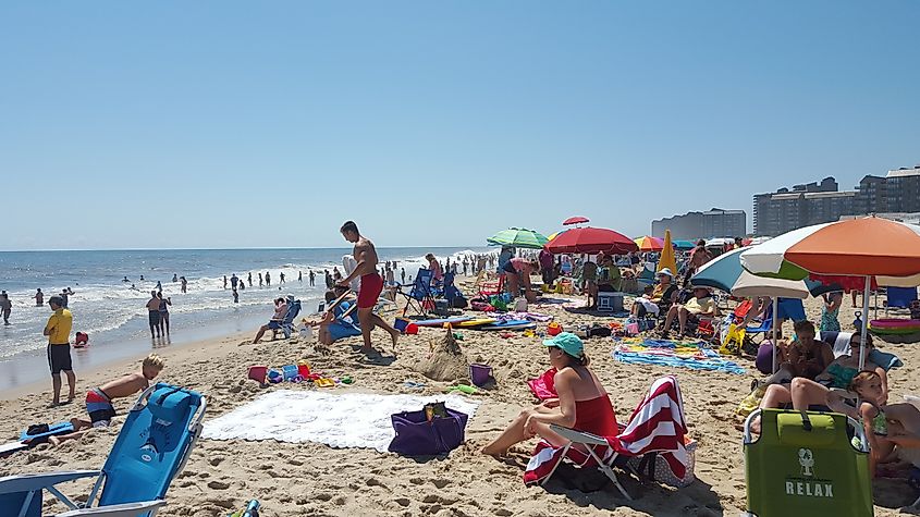 Looking south along the beach at Bethany Beach, Delaware, with the shoreline stretching into the distance and waves gently rolling onto the sand.