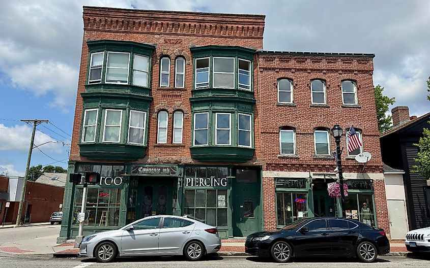 Vintage, red brick building with local businesses on Main Street in Willimantic, Connecticut.