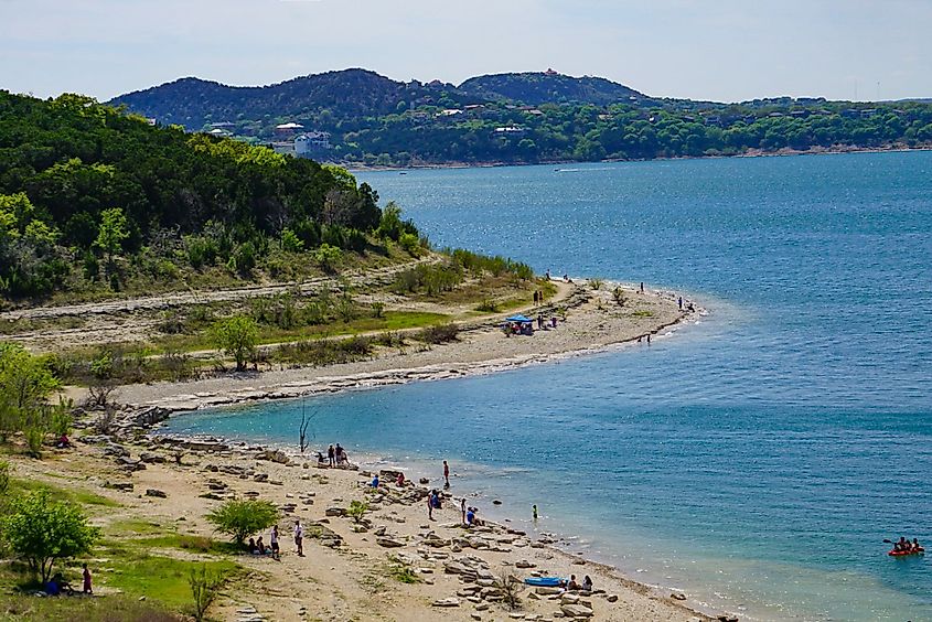 People enjoy along the shores of the Canyon Lake in Texas Hill Country