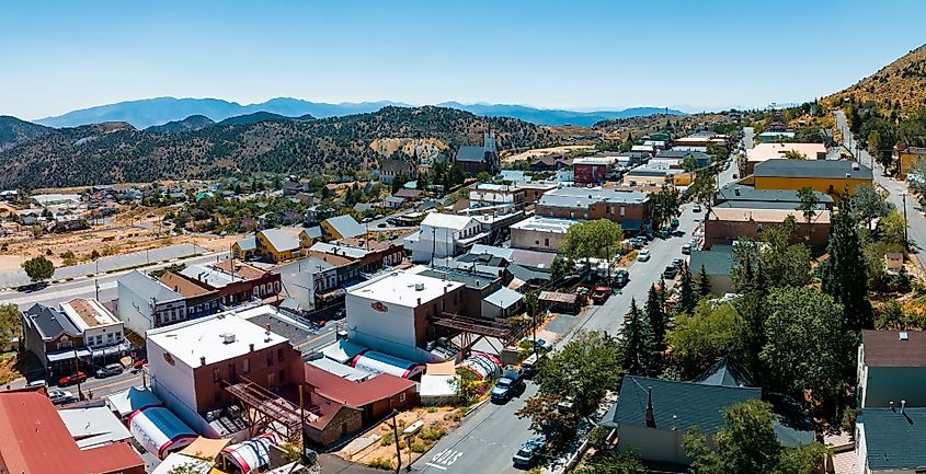 Aerial scenic view of Victorian buildings on historic Main C Street in downtown Virginia City, Nevada, USA, with cars parked along the street.