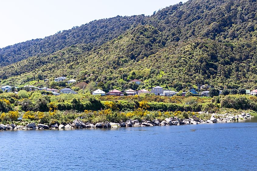 Charming houses sit near the Grey River in Greymouth, New Zealand