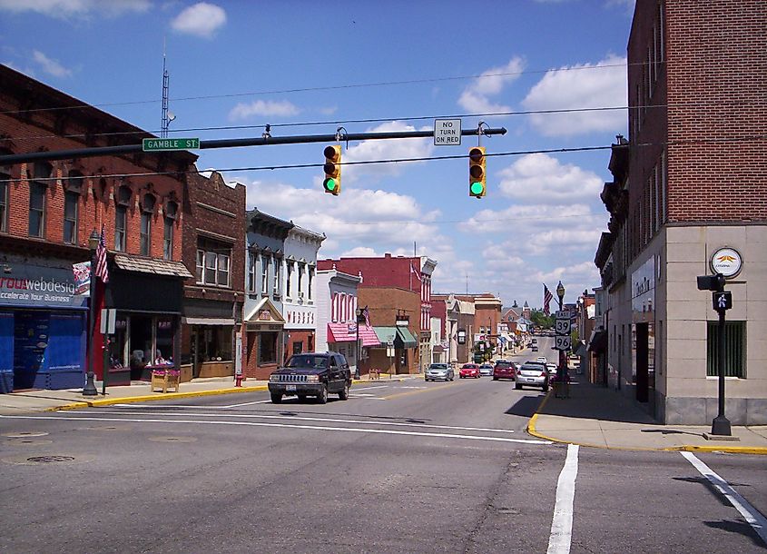 Downtown Shelby, Ohio, looking east along West Main Street at the intersection with Gamble Street, featuring local businesses and historic buildings