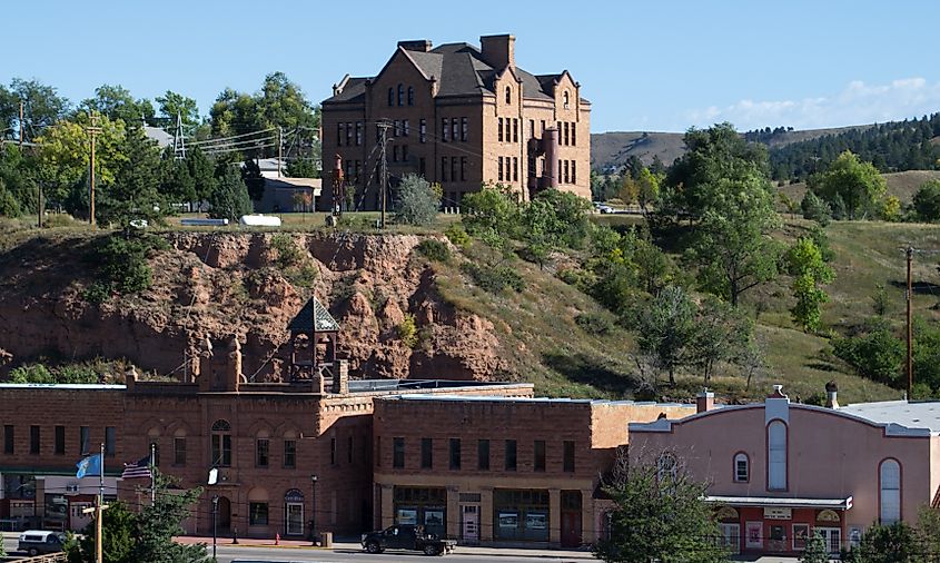 Hot Springs City Hall in South Dakota, featuring a bell tower, located below the Pioneer Museum