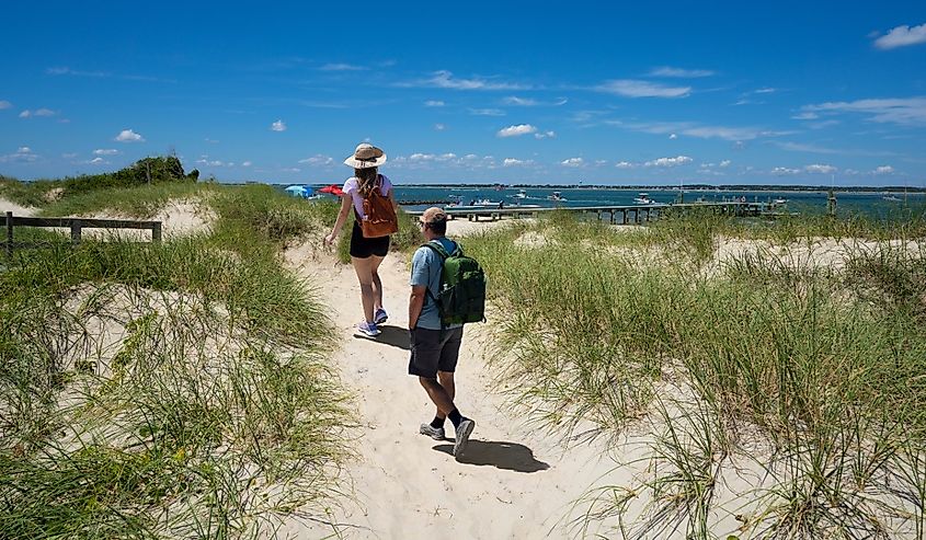 Couple hiking on the beach near Beaufort, North Carolina.