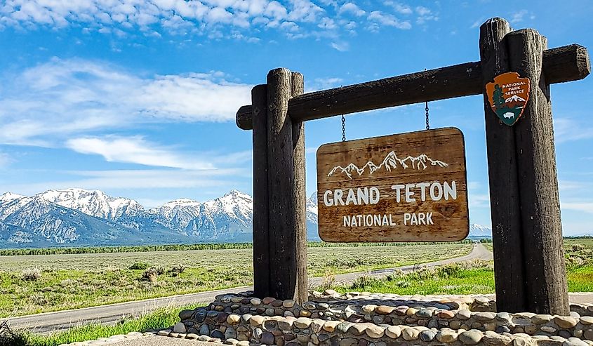 Grand Teton national Park sign and background with grand Tetons