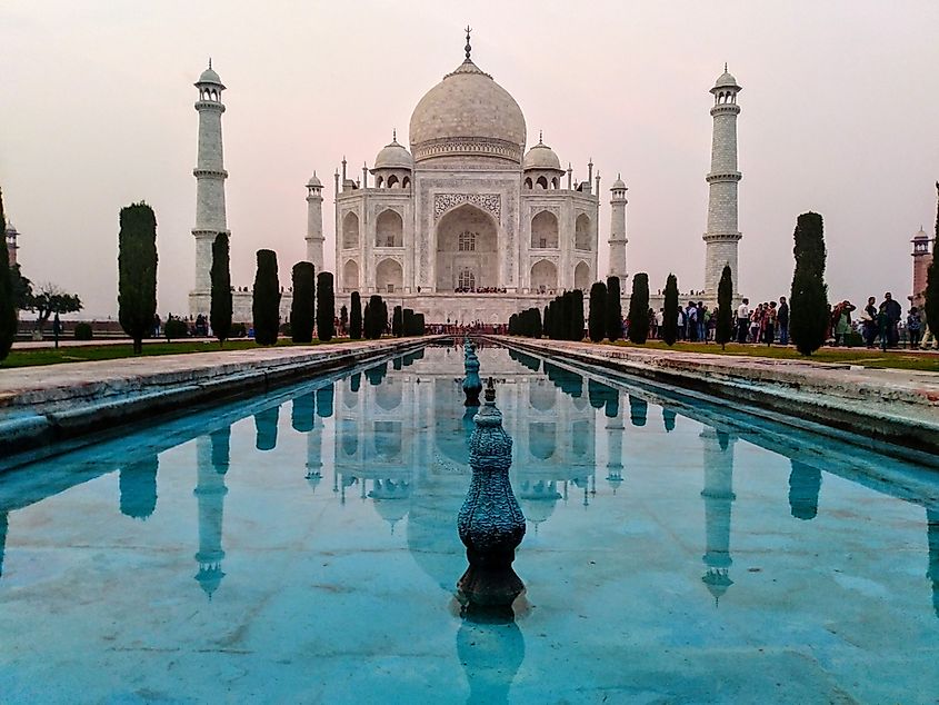 The Taj Mahal mausoleum in Agra, India, viewed from the entrance gate across the reflecting pool.