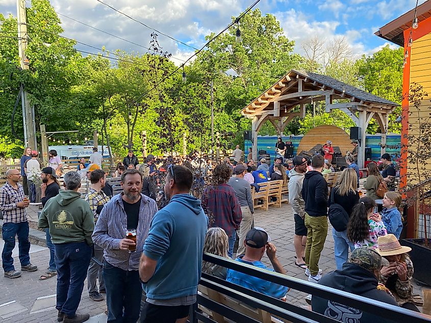 A large crowd gathers around a brewery's outdoor stage.