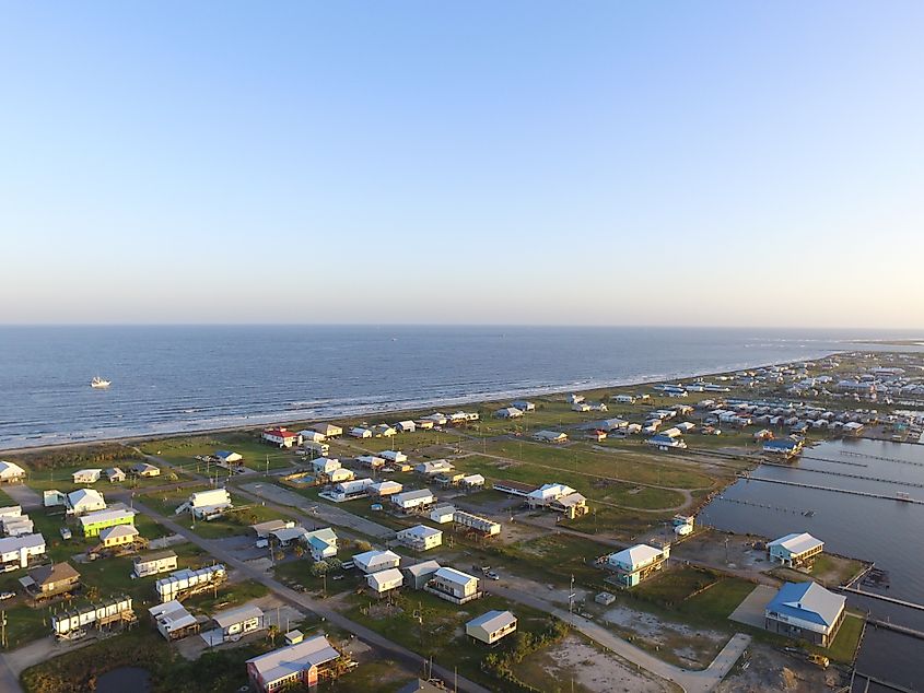 Sunset view of Grand Isle, Louisiana, featuring shrimp trawlers in the background.