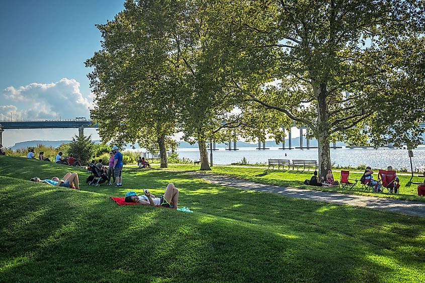 People relax on the lawn on in the Hudson River Walk Park in Tarrytown, New York. Editorial credit: Andrew F. Kazmierski / Shutterstock.com