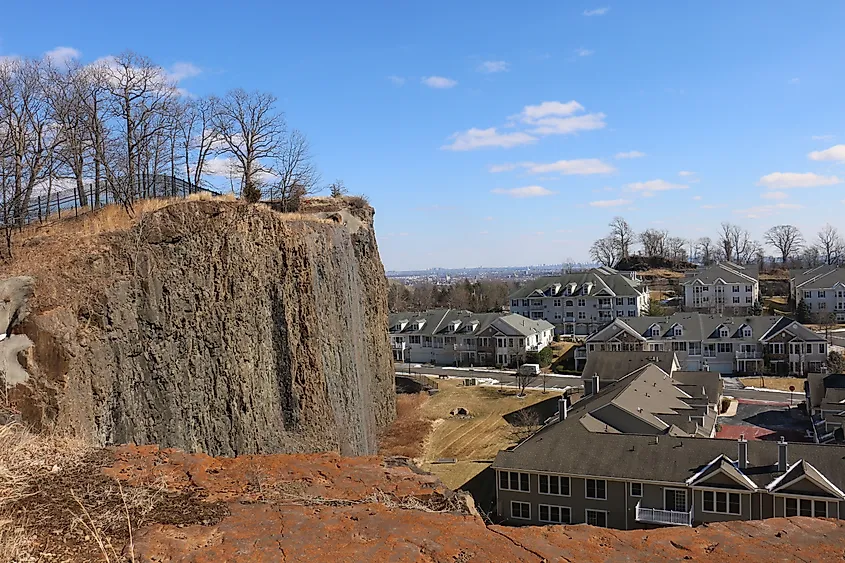 View of a cliff and the Four Seasons Great Notch condominium complex from Rifle Camp Park.