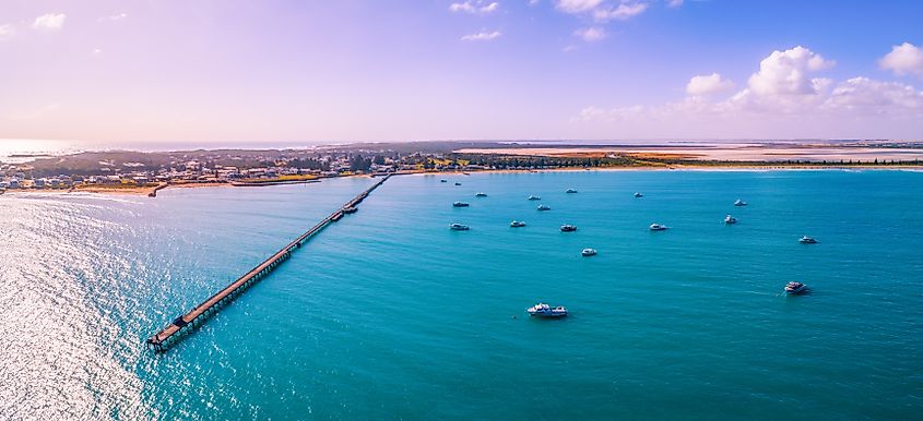 Beachport jetty and moored boats in South Australia at sunset.