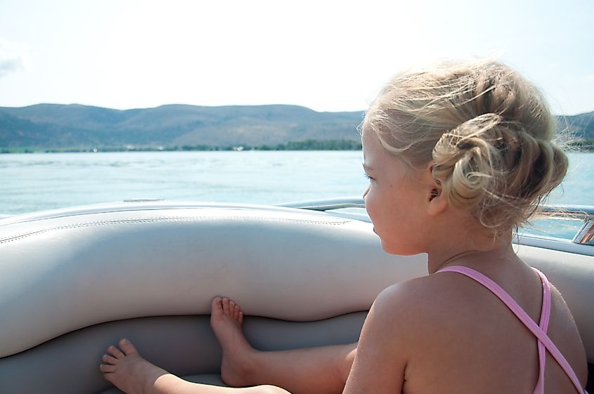 Young girl on a boat looks out over Bear Lake near Garden City, Utah.