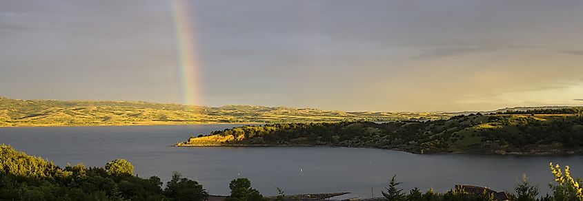 A rainbow arcs over the Missouri River at sunrise near Platte, South Dakota