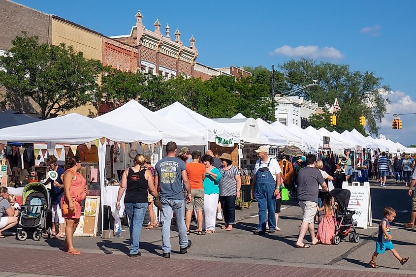 Crowds on a sunny day enjoying an art fair on Main Street in Howell, Michigan.