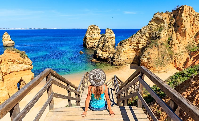 A visitor relaxes with a view of Praia do Camilo.