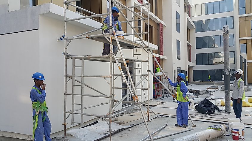 Construction workers at a building site in Abu Dhabi, UAE. Image Credit Kazzazm via Shutterstock.