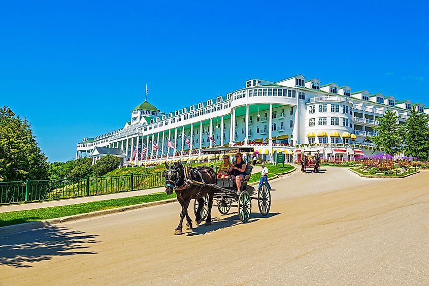 The Grand Hotel on Mackinac Island Michigan showing horse and buggy ride located on Lake Huron, Michigan. Editorial credit: Dennis MacDonald / Shutterstock.com