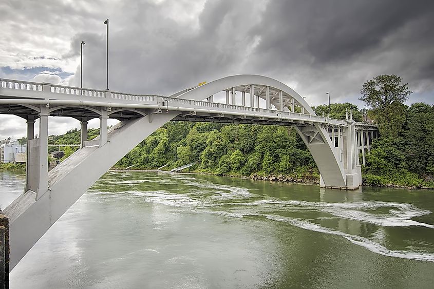 The Oregon City Arch Bridge spans over the Willamette River, connecting West Linn and Oregon City in Oregon.