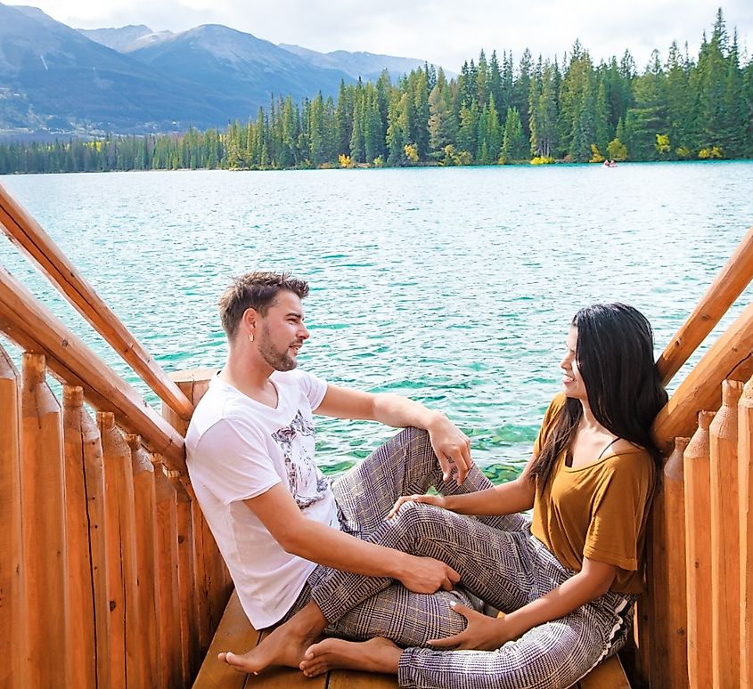 Couple at Beauvert Lake, sunrise by the lake at Jasper, Alberta.