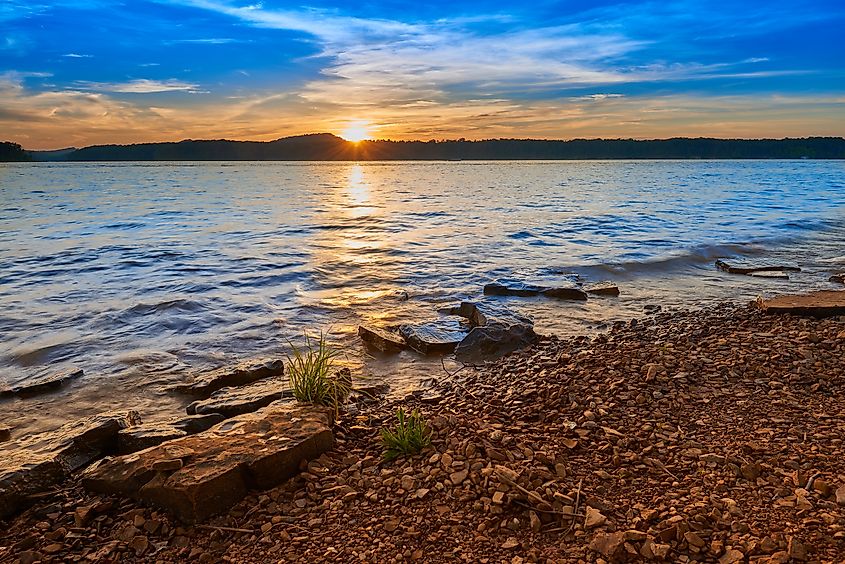 Sunset over Kentucky Lake, with vibrant colors reflecting on the water and surrounding natural scenery.