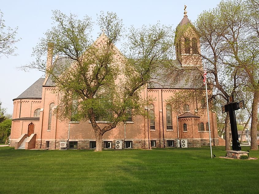 Saints Peter and Paul Catholic Church Complex in Strasburg, North Dakota, featuring a grand brick church with twin steeples, intricate stained glass windows, and historic architectural details.