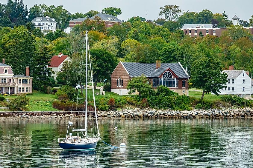 Sailboat anchored near shoreline of Castine, Maine, USA, an historic town and home of Maine Maritime Academy, for coastal, travel, and regional themes
