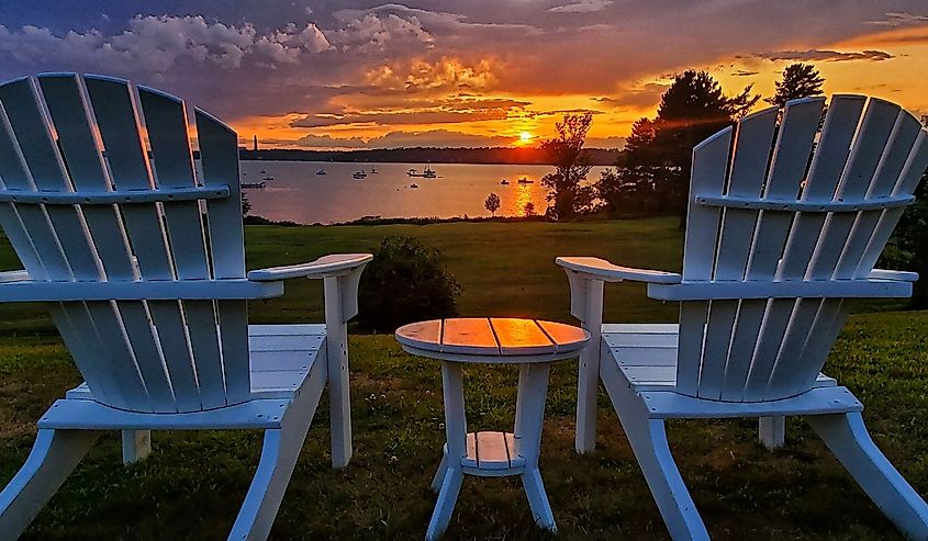 Two empty chairs overlooking a sunset on Chebeague Island