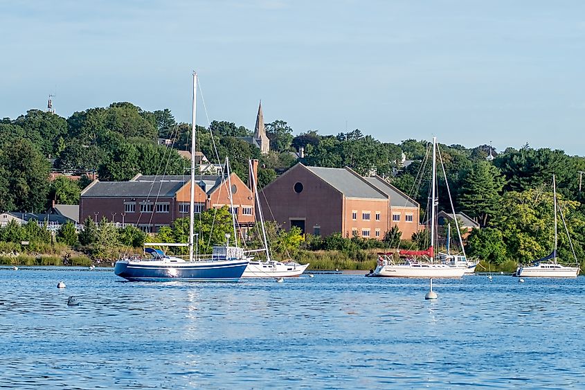 Waterfront scenes in East Greenwich, Rhode Island, featuring boats docked along the serene coastline with picturesque views of the surrounding area.