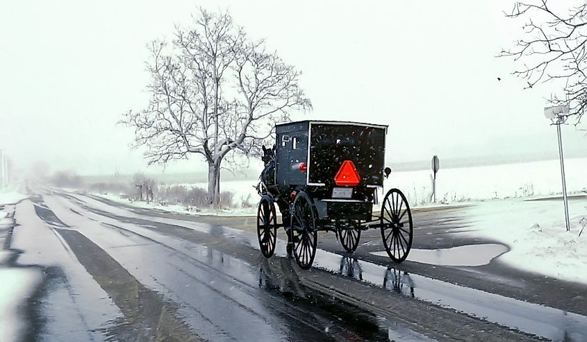 Amish horse and buggy on a lonely Road during a snowstorm in Shipshewana, Indiana.