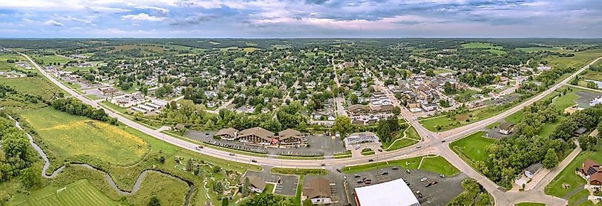 A panoramic photo of New Glarus, Wisconsin, facing west, showcasing the town's rolling hills, picturesque landscape, and Swiss-inspired architecture.