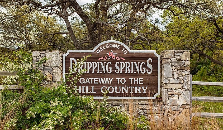 Welcome to Dripping Springs sign from this small town in the Texas Hill Country.