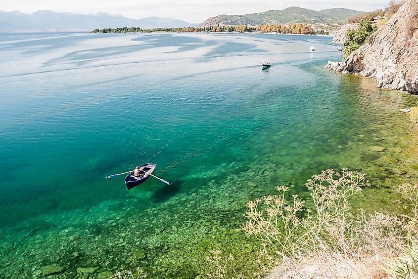 Man paddling a boat in Lake Ohrid