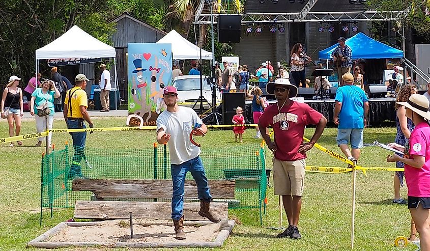 Man throwing horseshoe during the Sopchoppy Worm Grunting Festival