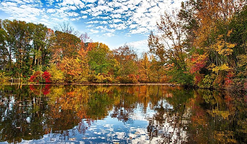 The changing leaves bring splashes of color to the historic Kirby's Mill pond in Medford, New Jersey.