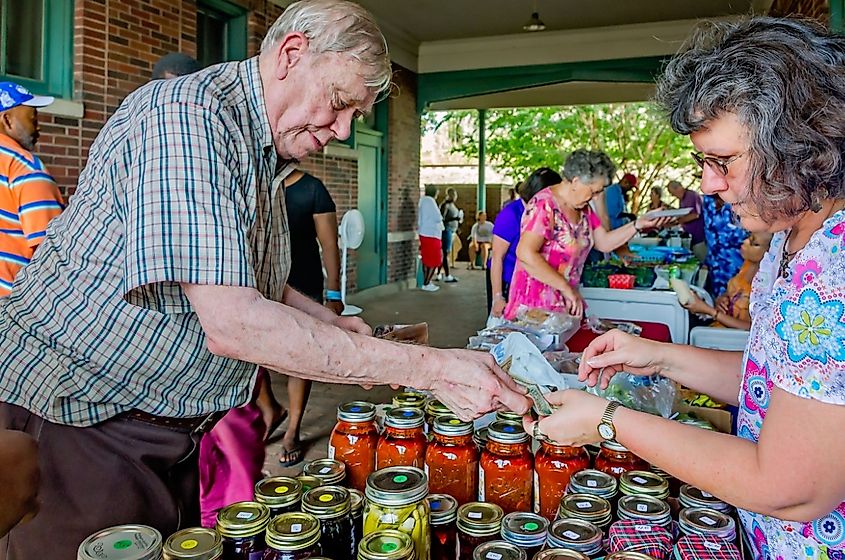 man buys pickled okra from a vendor at the Clarksdale Farmers Market in Clarksdale, Mississippi.