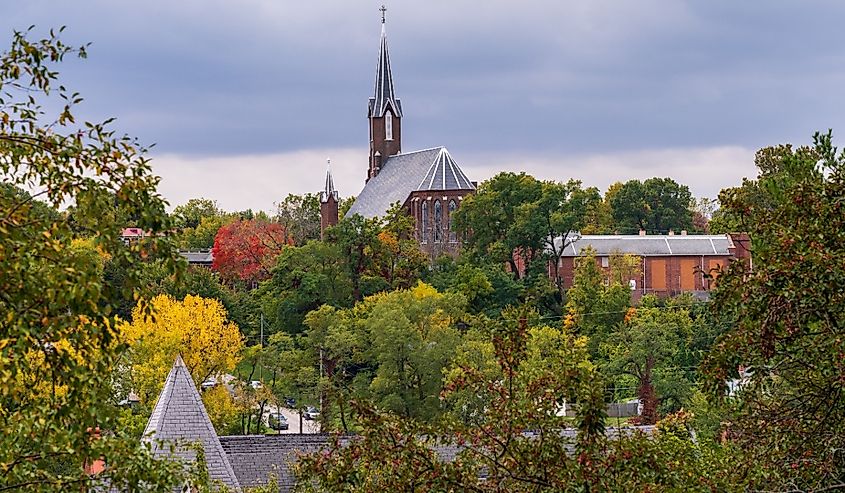 St John Catholic church among fall trees in the city of Burlington in Iowa